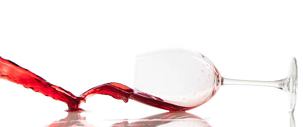 Pouring red wine in a glass stock photo