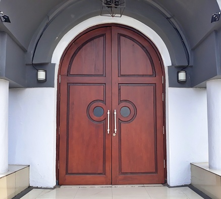 European style design wide and tall old wooden door building and architecture in Surabaya city. Dutch heritage building