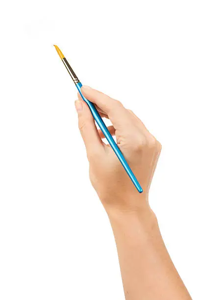 Photo of A single hand holding a blue paintbrush