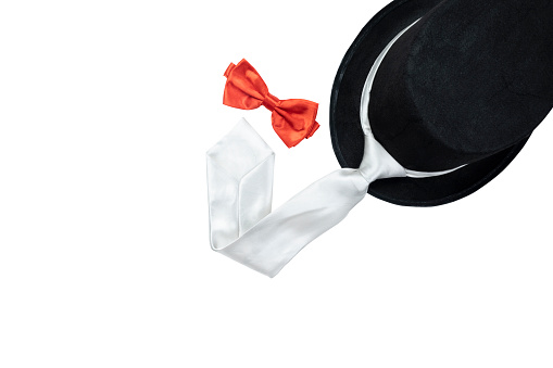 Black hat and silver tie with red bow tie isolated over white background