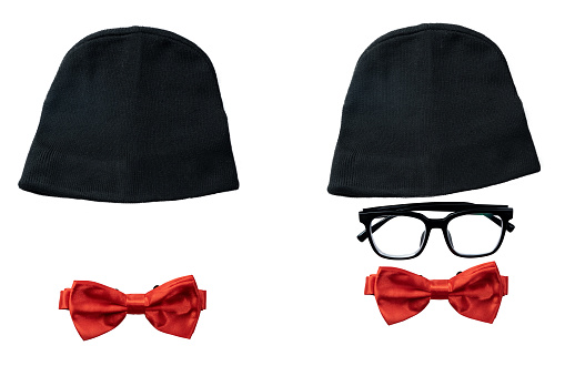 Black hat, eyeglasses, and red bow tie isolated over white background