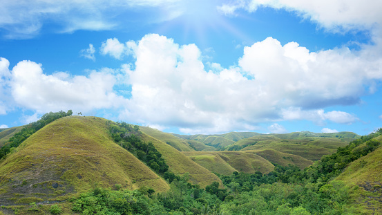 Green hills with a landscape view with a blue sky background. Nature background
