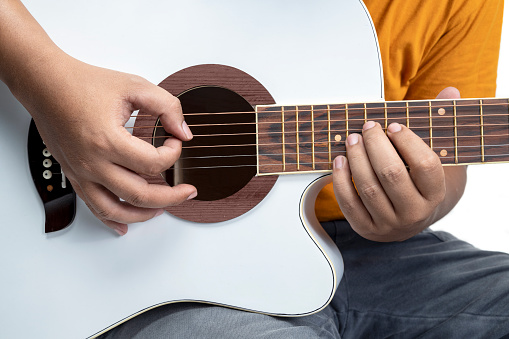 Man playing guitar isolated over white background