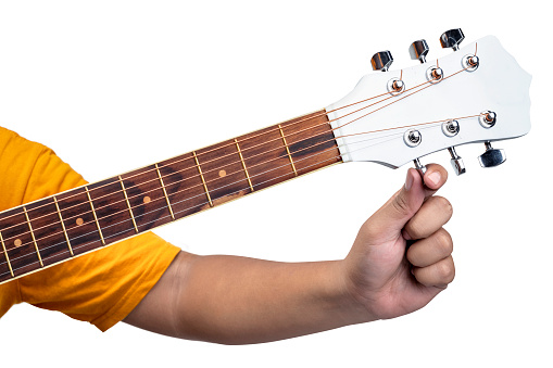 Man tuning guitar string isolated over white background