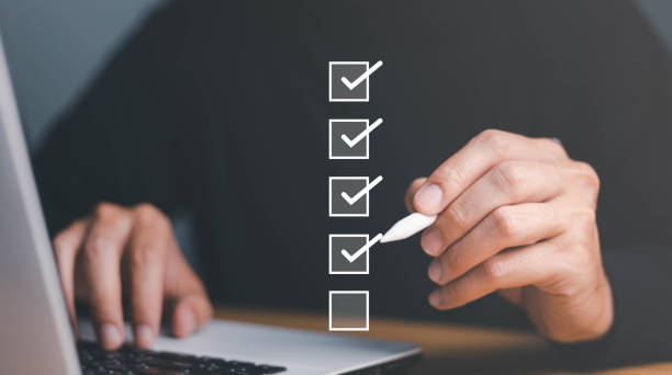 istock Businessman use pen to tick correct sign mark in checkbox for quality document control checklist and business approve project concept. 1568745508