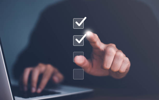 istock Businessman use finger to tick correct sign mark in checkbox for quality document control checklist and business approve project concept. 1568745602