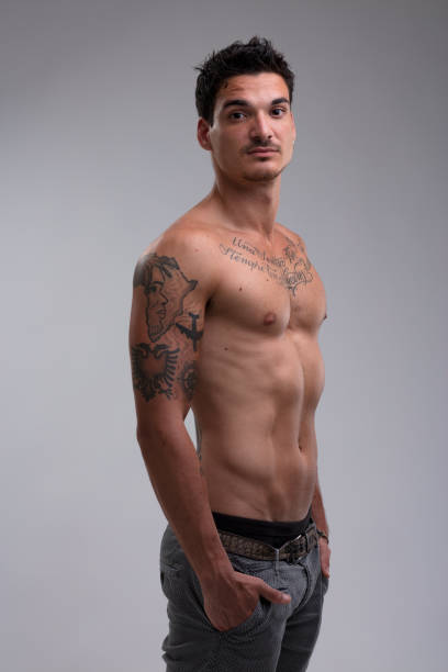 istock Fit, shirtless man, hands in pockets, proud midriff (tattooed ve 1568749721