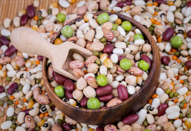 istock Mixed dried legumes and cereals isolated on white background, top view 1568749842