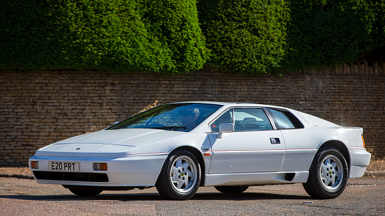 Turvey, Bedfordshire, UK - June 12th 2022. 1988 white Lotus Esprit driving on an English country road