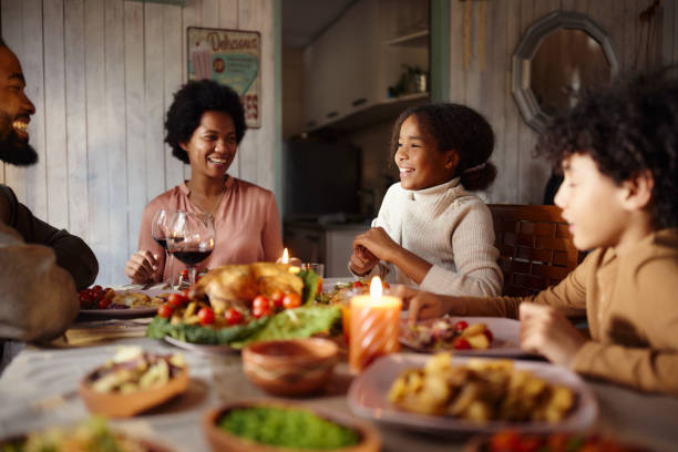 istock Happy black family talking during lunch in dining room. 1568755319