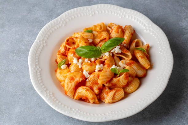 istock Tomato ravioli pasta or pipe rigate shaped pasta on the cheese 1568757535