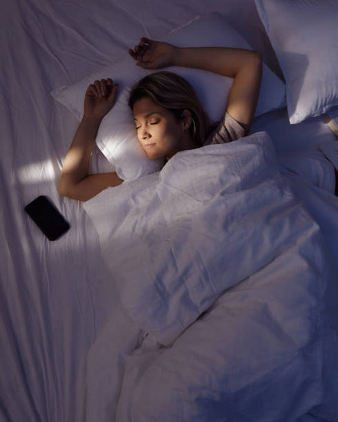 istock Above view of young woman sleeping in bed. 1568772665
