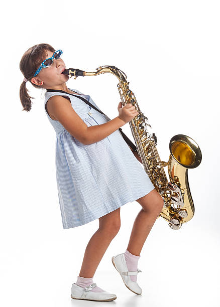 istock little girl playing music on saxophone 156879570