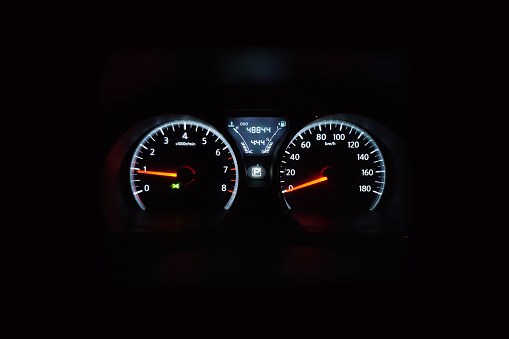 Car dashboard. Checking the system when starting the engine. A close-up of the speedometer and tachometer with additional instruments is illuminated