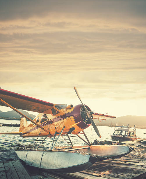 Floatplane in Sunset Float plane dock in Ketchikan Alaska.  Stitched images. bush plane stock pictures, royalty-free photos & images