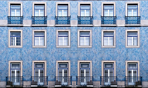 Texture of portuguese widnows on blue wall Lisbon windows with typical portuguese tiles on the wall portuguese culture photos stock pictures, royalty-free photos & images