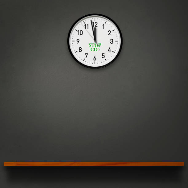 istock Wall clock with Stop CO2 letters above the wooden shelf 1568839306