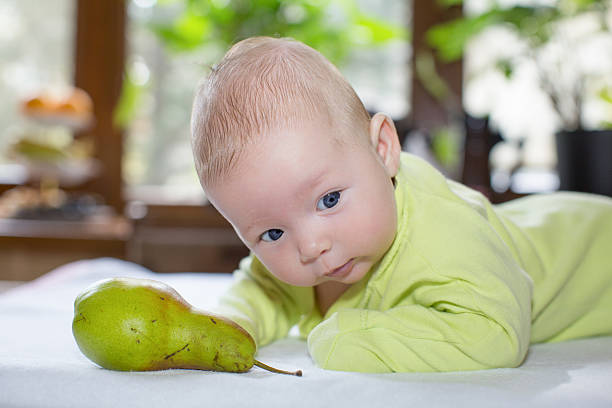istock baby girl  with fruit 156884530
