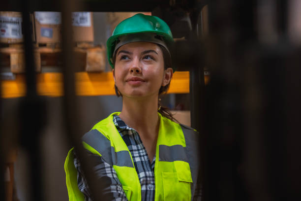 istock Woman driving forklift in warehouse 1568855118