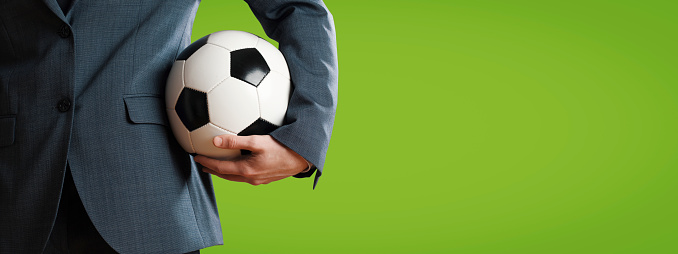 Manager holding a soccer ball close up, sports and management concept, blank copy space