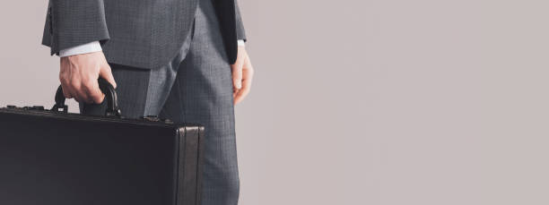 istock Corporate businessman holding a briefcase 1568881170