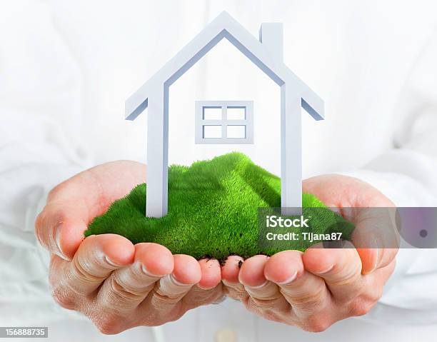 Male Hands Holding A Green Hill With Small House Stock Photo - Download Image Now - House, Environmental Conservation, Holding