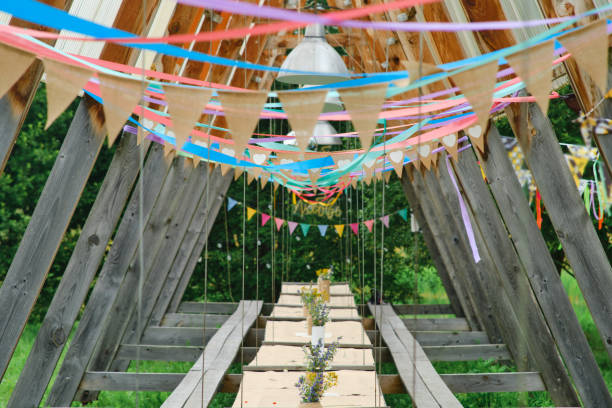 istock Large and long wooden table outdoors among the trees 1568894962