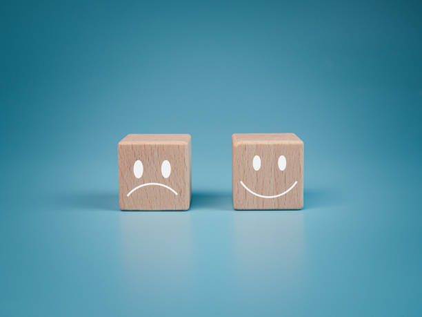 koncepcja zdrowia psychicznego i stanu emocjonalnego, uśmiechnięta twarz i smutna twarz na drewnianym kostce bloku dla pozytywnej koncepcji wyboru nastawienia. - charaktery zdjęcia i obrazy z banku zdjęć