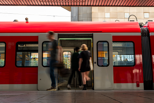 Motion blurred people walking on railway platform. Munchen, Germany.