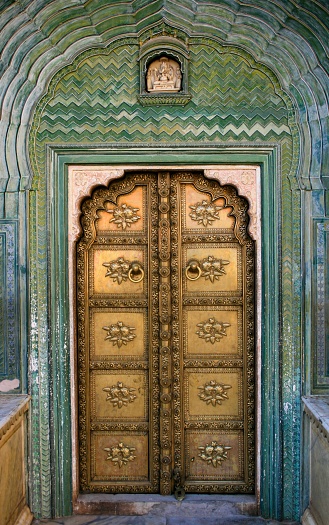 Agra, India – July 01, 2013: An ornate door at the Chandra Mahal, Jaipur City Palace in Jaipur, Rajasthan, India.