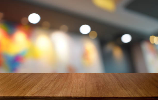 istock Wood table top in front of abstract blurred background. Empty wooden table space for text marketing promotion. blank wood table surface copy space 1568911136
