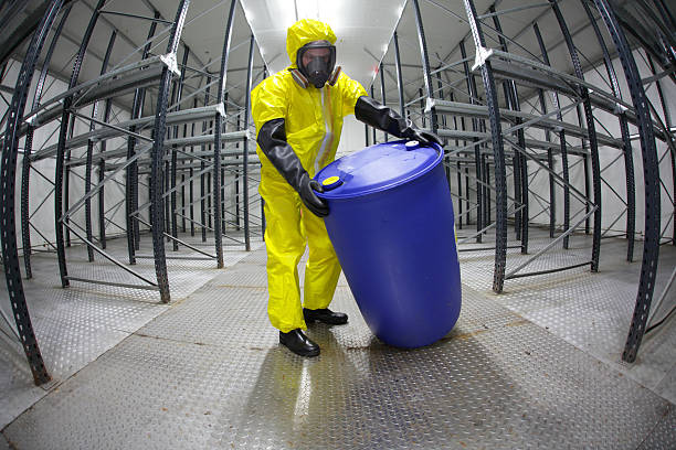 istock technician rolling barrel of chemicals in empty storehouse 156891242