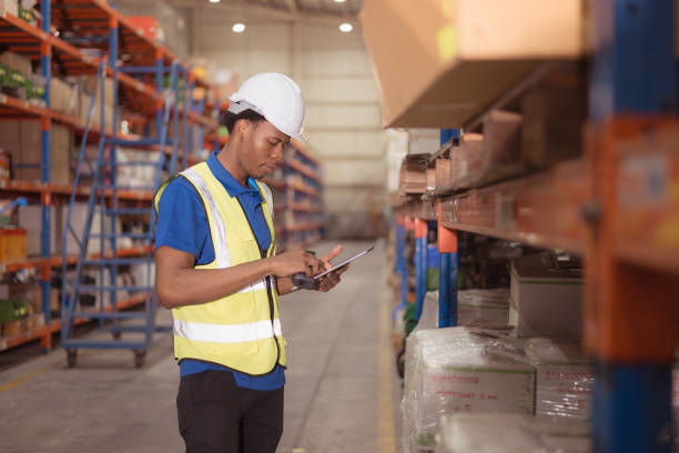 istock Portrait of smiling male warehouse worker using digital tablet in a warehouse 1568915071