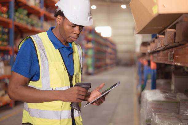 istock Portrait of smiling male warehouse worker using digital tablet in a warehouse 1568915086