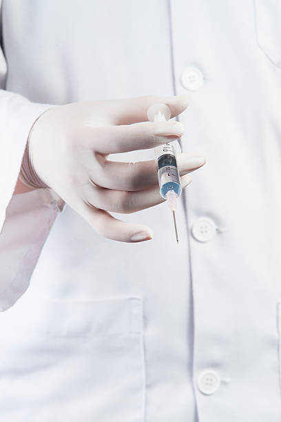 istock Doctor / Nurse holding a syringe 156891516