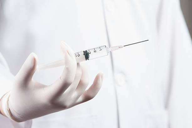 istock Doctor / Nurse holding a syringe 156891765