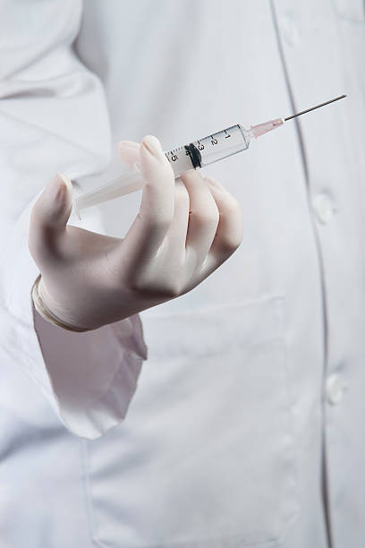 istock Doctor / Nurse holding a syringe 156891784
