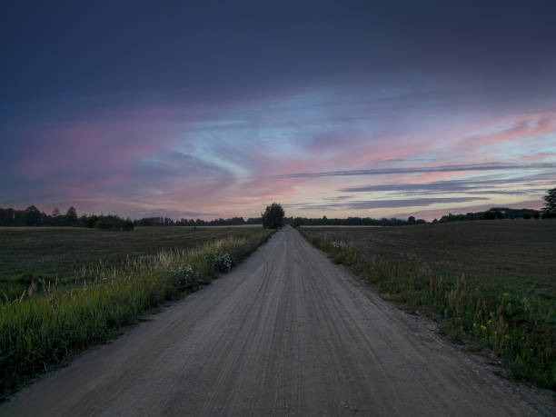 Empty country road. The sun is setting. Perspective. Lithuania