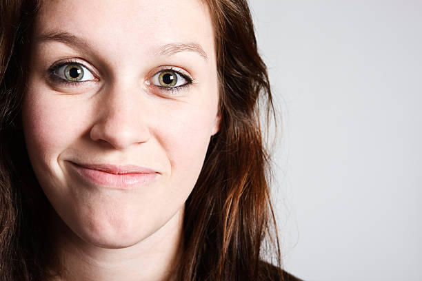 istock Pretty redhead gives lopsided smile 156893691