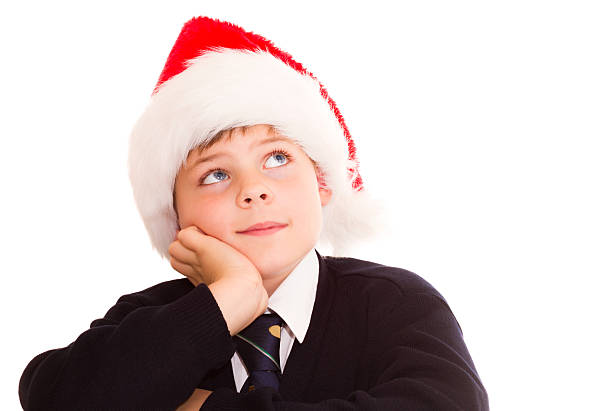 Cute schoolboy waiting for the holidays. Isolated on white. stock photo
