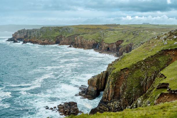 istock Scenic view of rocky cliffs overlooking the vast blue ocean in Cornwall, UK. 1568942641