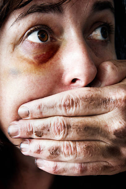 istock Battered woman is silenced by man's hand over her mouth 156894443