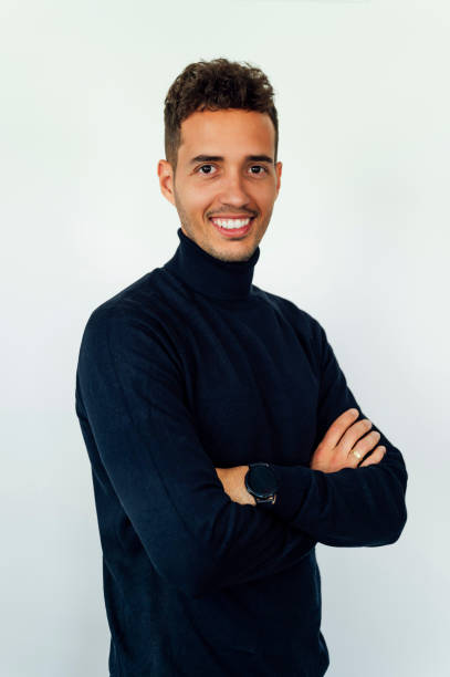 istock Smiling man with arms crossed on white background sideways 1568951594