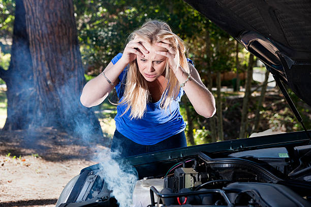 istock Pretty blonde frustrated and frantic about smoking broken-down car 156895913