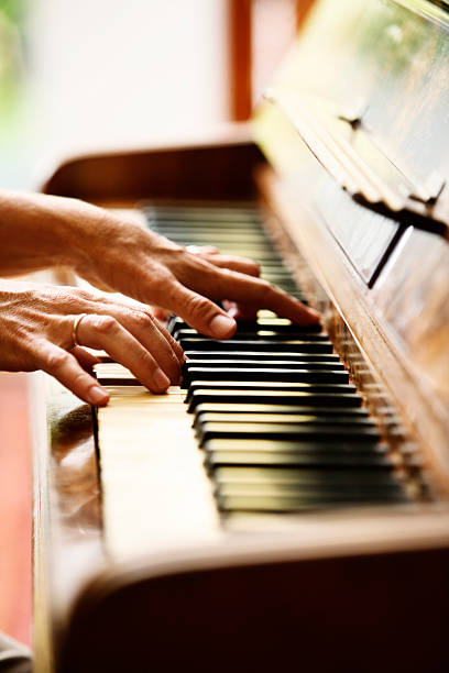 istock Woman's hands playing antique German piano 156897061