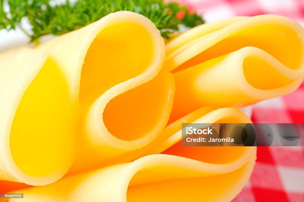 folded slices of cheese thin folded slices of fresh cheese with a parsley on a white plate and a chequered cloth Checked Pattern Stock Photo