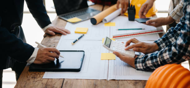 istock Engineer Teamwork Meeting, Drawing working on blueprint meeting for project working with partner on model building at company office. Asian industry professional team 1568985203