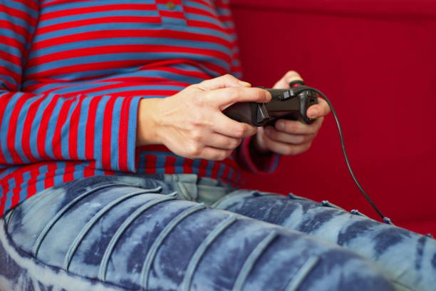 istock Woman playing video games 1568985265