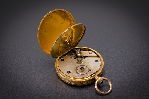 Vintage Swiss clockwork mechanism. Gold pocket watch on stone background. Gold Silver Precision Antique Vintage Pocket Watch Bodies Parts