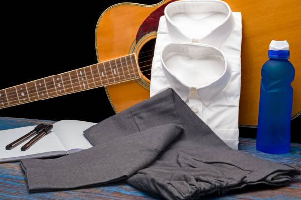 istock Shirts and trousers ready for school term to begin image showing two wrapped shirts and a pair of childs grey trousers 1569001082
